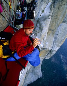 Kevin Brown drinks water near the end of a multi-day ascent of El Capitan in Yosemite Valley in 2003.  The Big Wall route called "Excalibur" is rated grade VI 5.8 A3. (Photo by Kevin Steele/Aurora)